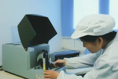 technician testing optical performance of packaging material sample