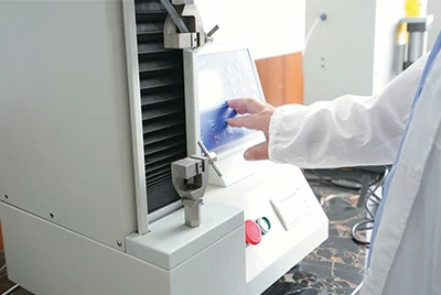 laboratory technician operating analytical testing equipment for aluminum foil packaging materials